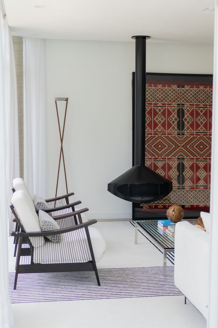 Crafting Captivating Headlines: Your awesome post title goes here Stylish modern living room featuring a hanging fireplace and elegant decor.